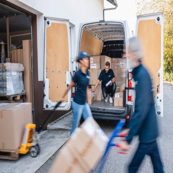 Freight shipping workers unloading boxes from truck