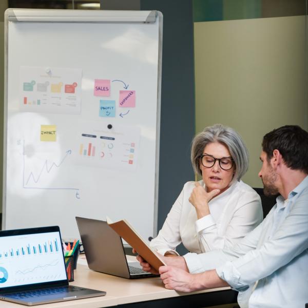 Business man and woman looking at reports