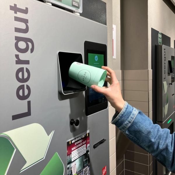 A person returning their cup to a machine for Berlin reuse pilot